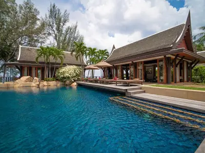 a house with a swimming pool in front of a house at Villa Chada in Kamala Beach
