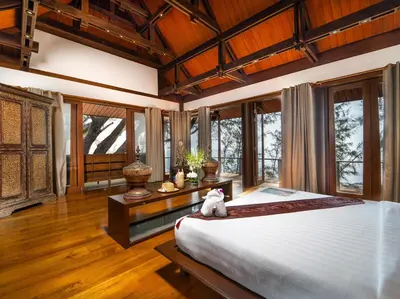 a bedroom with a bed with a stuffed animal sitting on it at Villa Chada in Kamala Beach