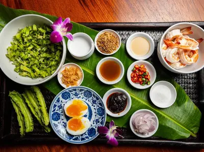 a tray of food with eggs and other ingredients at Villa Chada in Kamala Beach