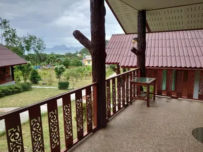 a balcony of a building with a bench on it at Mookanda bungalow in Ko Yao Noi