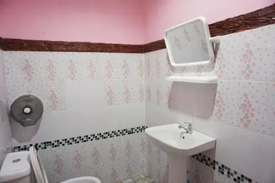 a bathroom with a sink and a toilet and a mirror at Mookanda bungalow in Ko Yao Noi