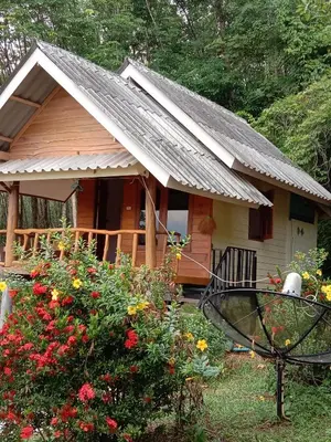 a small house with a metal roof and some flowers at Mookanda bungalow in Ko Yao Noi
