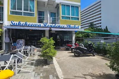 two motorcycles parked in front of a building at Sukcheewa Residence Phuket in Patong Beach