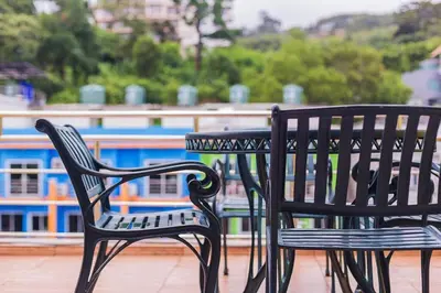 two black chairs and a table on a roof at Sukcheewa Residence Phuket in Patong Beach