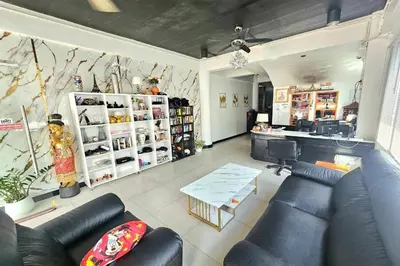 a living room with a blue couch in a store at Sukcheewa Residence Phuket in Patong Beach