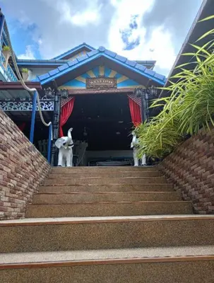 two dogs standing on the stairs of a building at Patong Sunbeach Mansion in Patong Beach