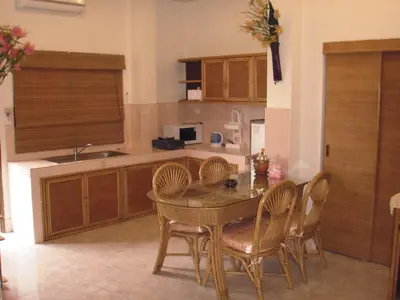 a kitchen with a table and chairs and a kitchen with a sink at Patong Sunbeach Mansion in Patong Beach