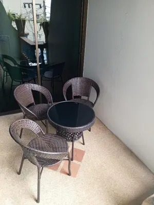 a group of chairs and a table in a room at Patong Sunbeach Mansion in Patong Beach