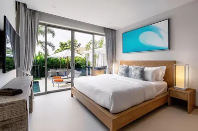 a bedroom with a large bed and a large window at Modern 3BR Villa with Private Pool and BBQ in Bang Tao Beach