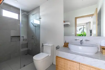 a bathroom with a toilet and a sink and a shower at Modern 3BR Villa with Private Pool and BBQ in Bang Tao Beach