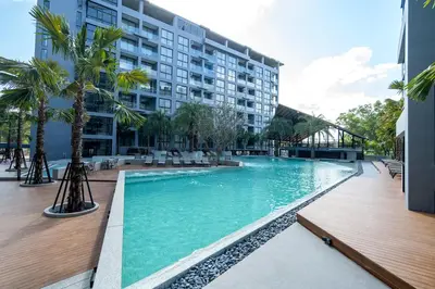 a swimming pool in front of a building at Citygate Kamala Resort and Residence - Official Account in Kamala Beach