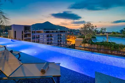 a hotel swimming pool with a view of the city at Citygate Kamala Resort and Residence - Official Account in Kamala Beach