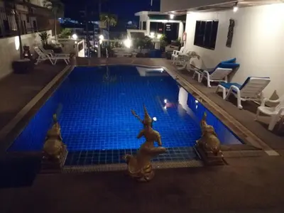 a swimming pool with blue tiles in a building at Blue Sky Residence in Patong Beach