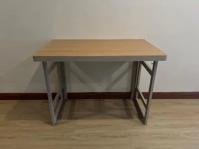 a small wooden table sitting on top of a floor at The Passion Nest - SHA Plus Certified in Phuket Town