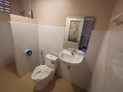 a small bathroom with a sink and a toilet at The Passion Nest - SHA Plus Certified in Phuket Town