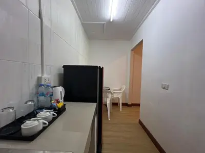 a kitchen with a black and white counter top at The Passion Nest - SHA Plus Certified in Phuket Town