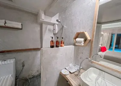 a small bathroom with a sink and a mirror at The Parlour Krabi in Klong Muang Beach