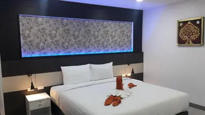 a bedroom with a bed with a stuffed animal on it at Heaven Apartments in Patong Beach