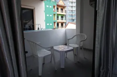 a small table and two chairs on a balcony at Heaven Apartments in Patong Beach