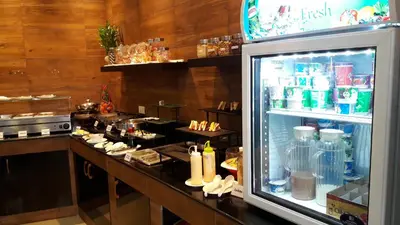 a kitchen with a refrigerator with food in it at Heaven Apartments in Patong Beach