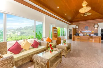 a living room with a couch and a table at The View Rawada Phuket in Rawai Beach