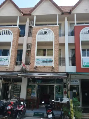 a building with motorcycles parked in front of it at We Love Kata in Kata Beach