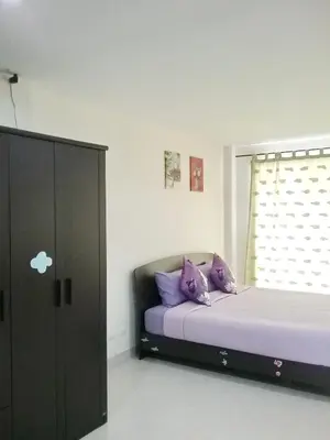a bedroom with two beds with purple pillows at We Love Kata in Kata Beach