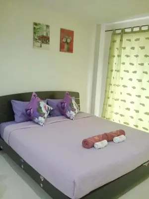 a bedroom with a bed with two towels on it at We Love Kata in Kata Beach