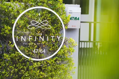 a sign that says the infinity on a bush at The Infinity Private Pool Villa in Phuket Town