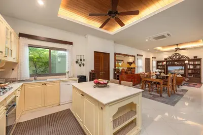 a kitchen with a ceiling fan and a dining room at VILLA LETI 22 meters Pool Naiharn Beach in Rawai Beach