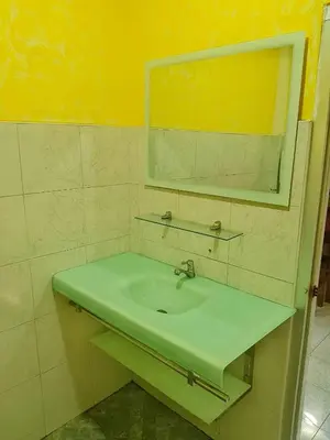a bathroom with a sink and a mirror at Ban Elephant Blanc Bungalow in Kata Beach