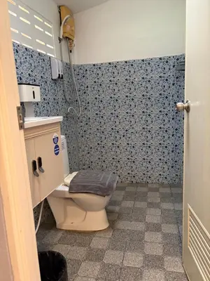 a bathroom with a toilet and a shower at Ban Elephant Blanc Bungalow in Kata Beach