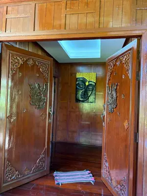 two doors in a room with wooden walls at Ban Elephant Blanc Bungalow in Kata Beach