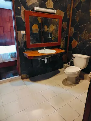a bathroom with a toilet and a sink and a mirror at Ban Elephant Blanc Bungalow in Kata Beach