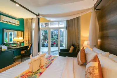 a bedroom with a large bed with a large window at Baan PhuAnda Phuket in Phuket Town