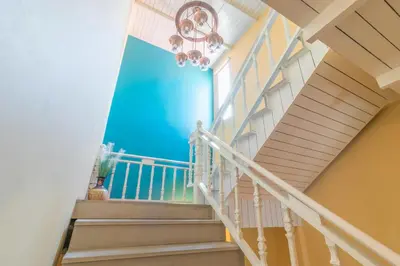 a staircase in a house with a blue wall at Baan PhuAnda Phuket in Phuket Town