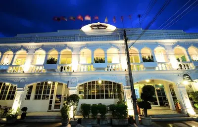 a large white building with lights on it at night at Baan PhuAnda Phuket in Phuket Town