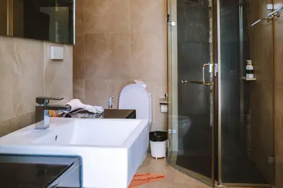 a bathroom with a sink and a toilet and a shower at Layantara Villas in Layan Beach