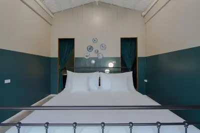 a large bed with white pillows in a room at Blu Monkey Boutique Phuket Town in Phuket Town