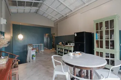 a room with a table and chairs and a refrigerator at Blu Monkey Boutique Phuket Town in Phuket Town