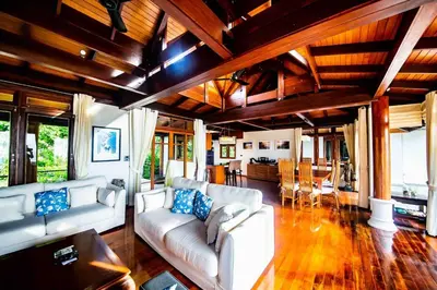 a living room with a white couch and a table at Luxury 4 bedrooms Villa with Seaview Infinity Pool overlooking Surin Beach in Surin Beach