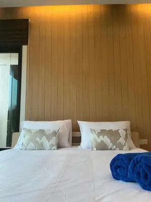 a white bed with two pillows on top of it at Loma Place in Ao Nang Beach