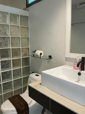 a bathroom with a white sink and a toilet at Loma Place in Ao Nang Beach