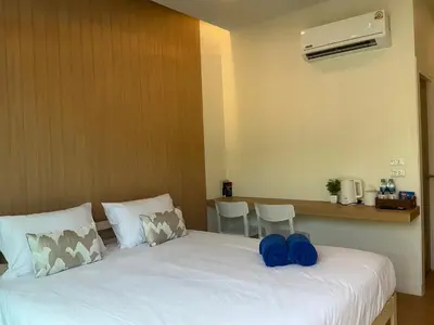 a bedroom with a bed with blue pillows on it at Loma Place in Ao Nang Beach
