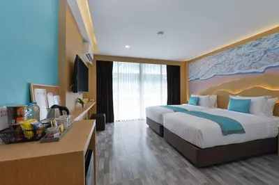 a hotel room with a large bed and a desk at T2 Ao Nang Krabi in Ao Nang Beach