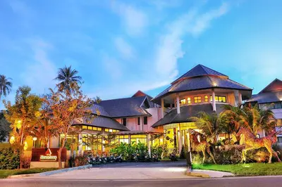 a large house with a lot of windows at Navatara Phuket Resort in Rawai Beach