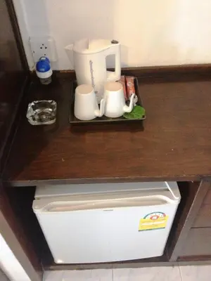 a counter top with a coffee maker and mugs at Bliss Resort Krabi in Klong Muang Beach