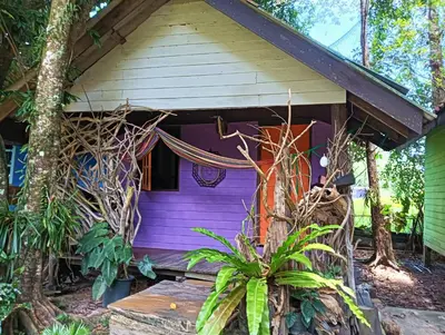 a purple house with a porch at Ko Yao Noi Sabai Bungalows in Ko Yao Noi