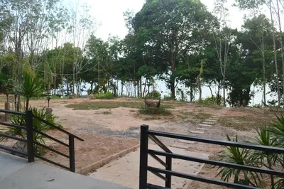 a park with a fence and a body of water at Camp Hadee Koh Yao Noi in Ko Yao Noi