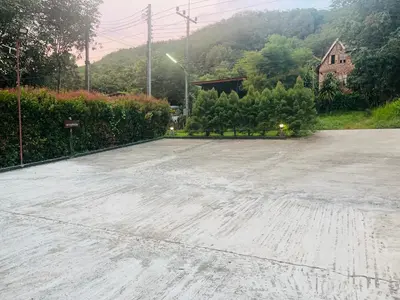 an empty parking lot with trees and a house at Najjamee Bungalows in Ko Yao Noi
